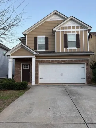 a front view of a house with garage