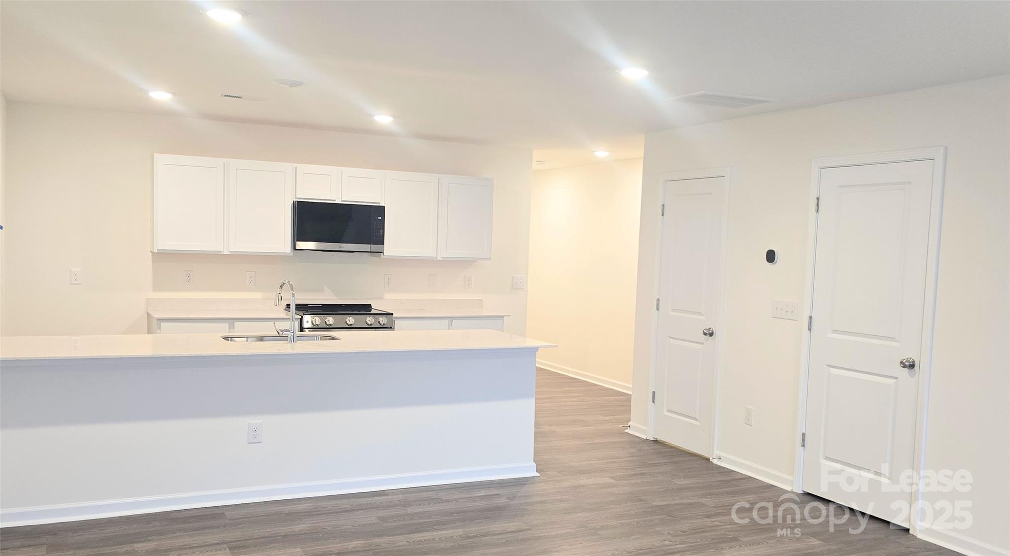 a view of kitchen with stainless steel appliances cabinets and outdoor space