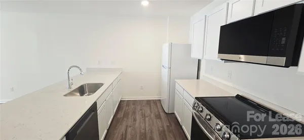 a kitchen with a sink and a microwave
