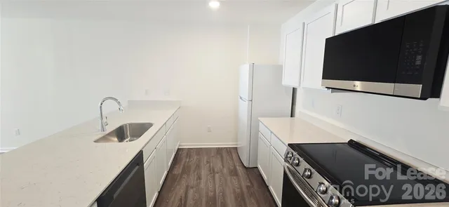 a kitchen with a sink and a microwave