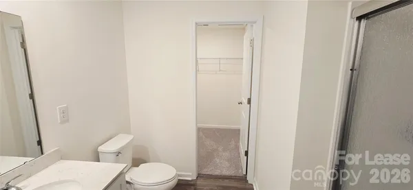 a white toilet sitting next to a bathroom sink