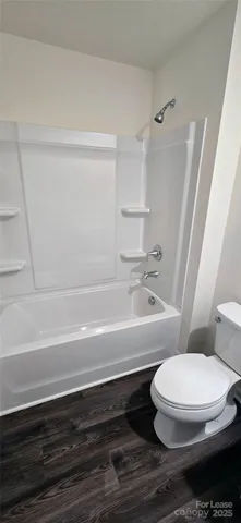 a bathroom with a toilet and a bathtub