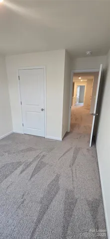 a view of an empty room and a window