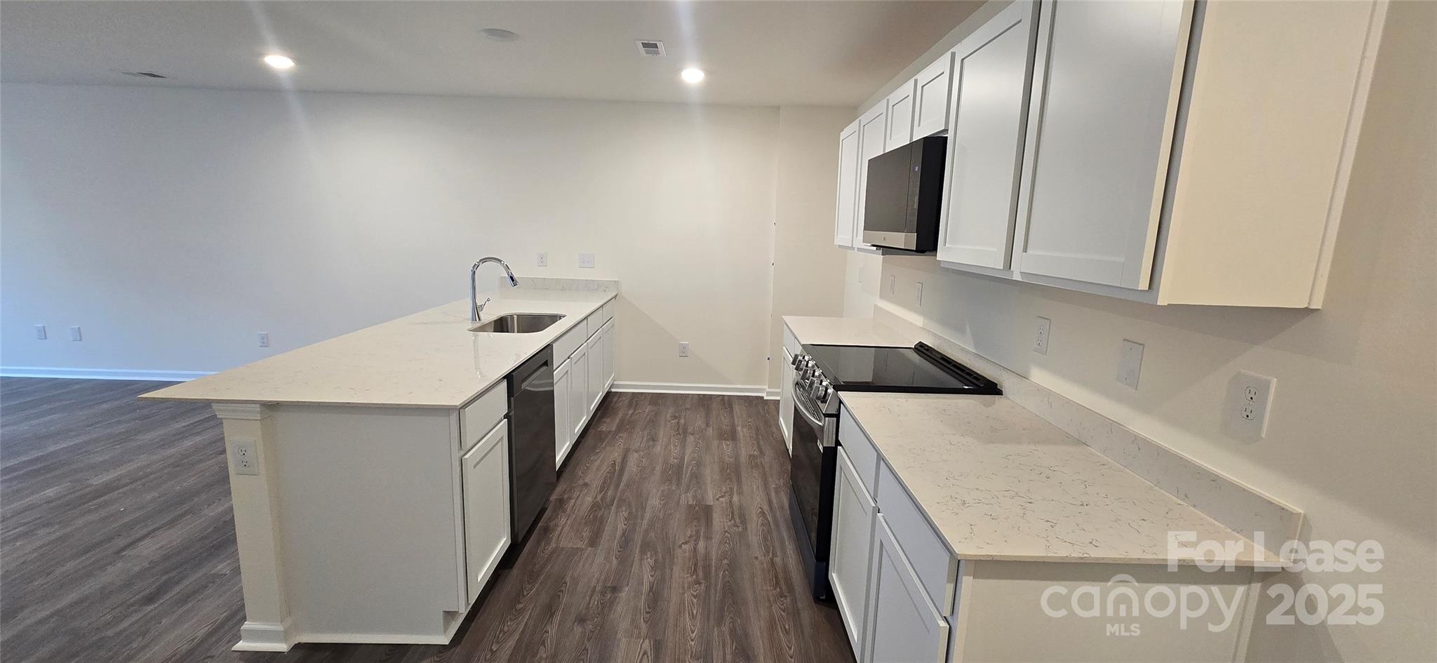1931 B Tranquility Circle Newton, NC 28658 - Photo 2 of 20 a kitchen with a sink a microwave and cabinets