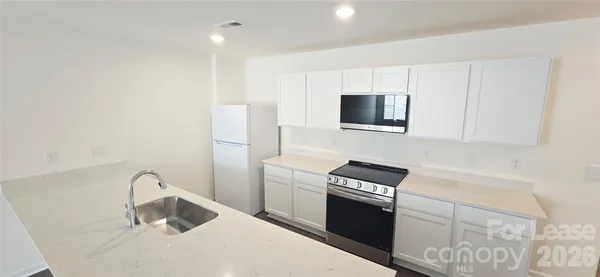 a kitchen with a sink cabinets and appliances