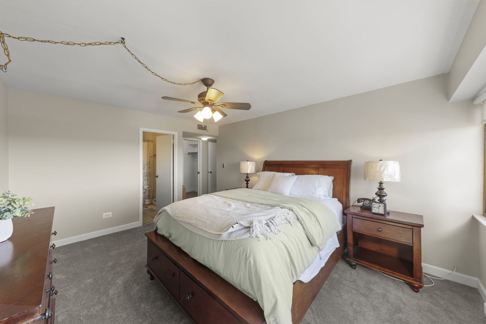 141 North La Grange Road, Unit 803 La Grange, IL 60525 - Photo 11 of 21 a bedroom with a bed and a chandelier