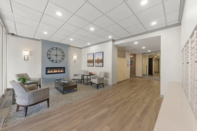 a living room with furniture a flat screen tv and a large window