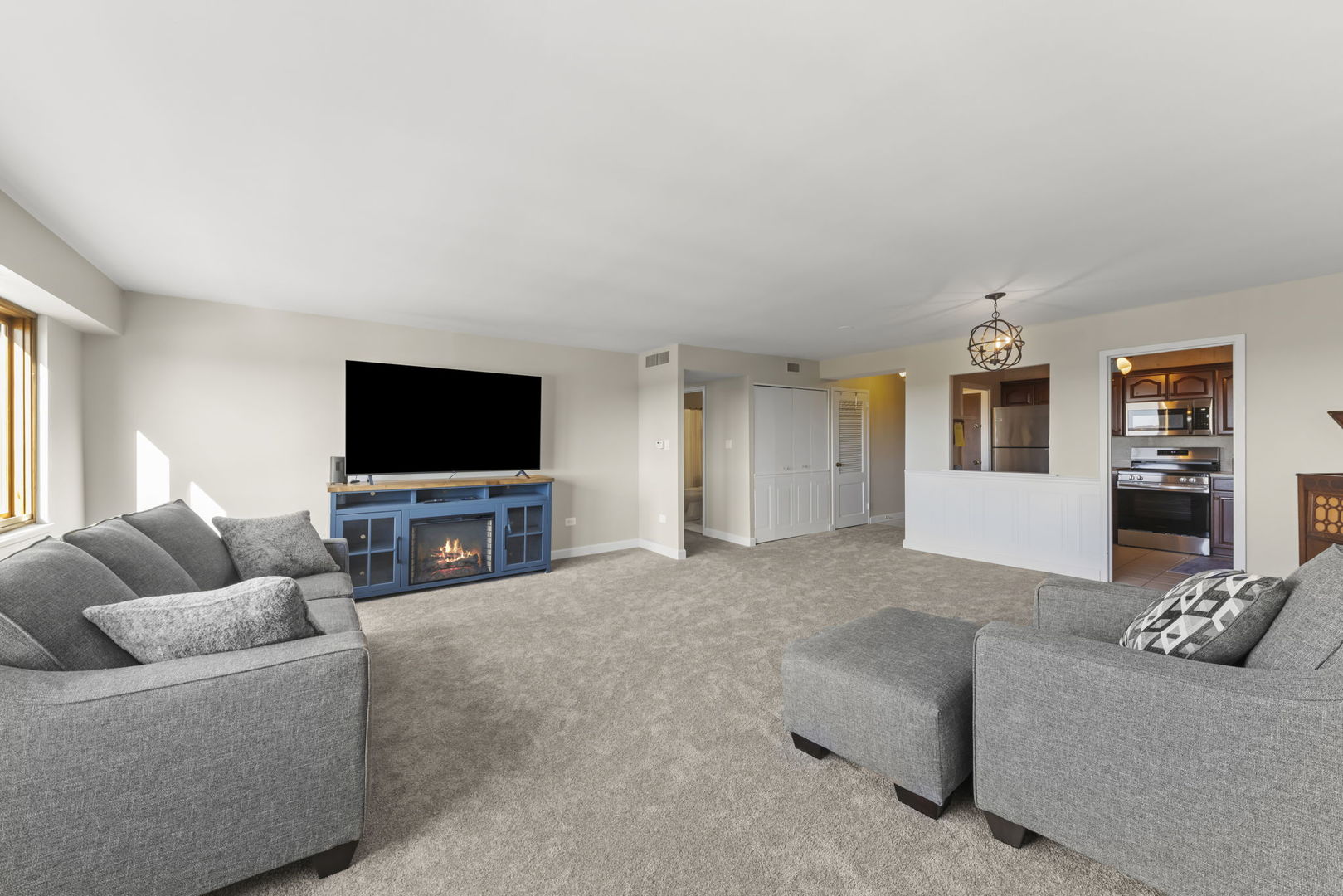 141 North La Grange Road, Unit 803 La Grange, IL 60525 - Photo 5 of 21 a living room with furniture and a flat screen tv