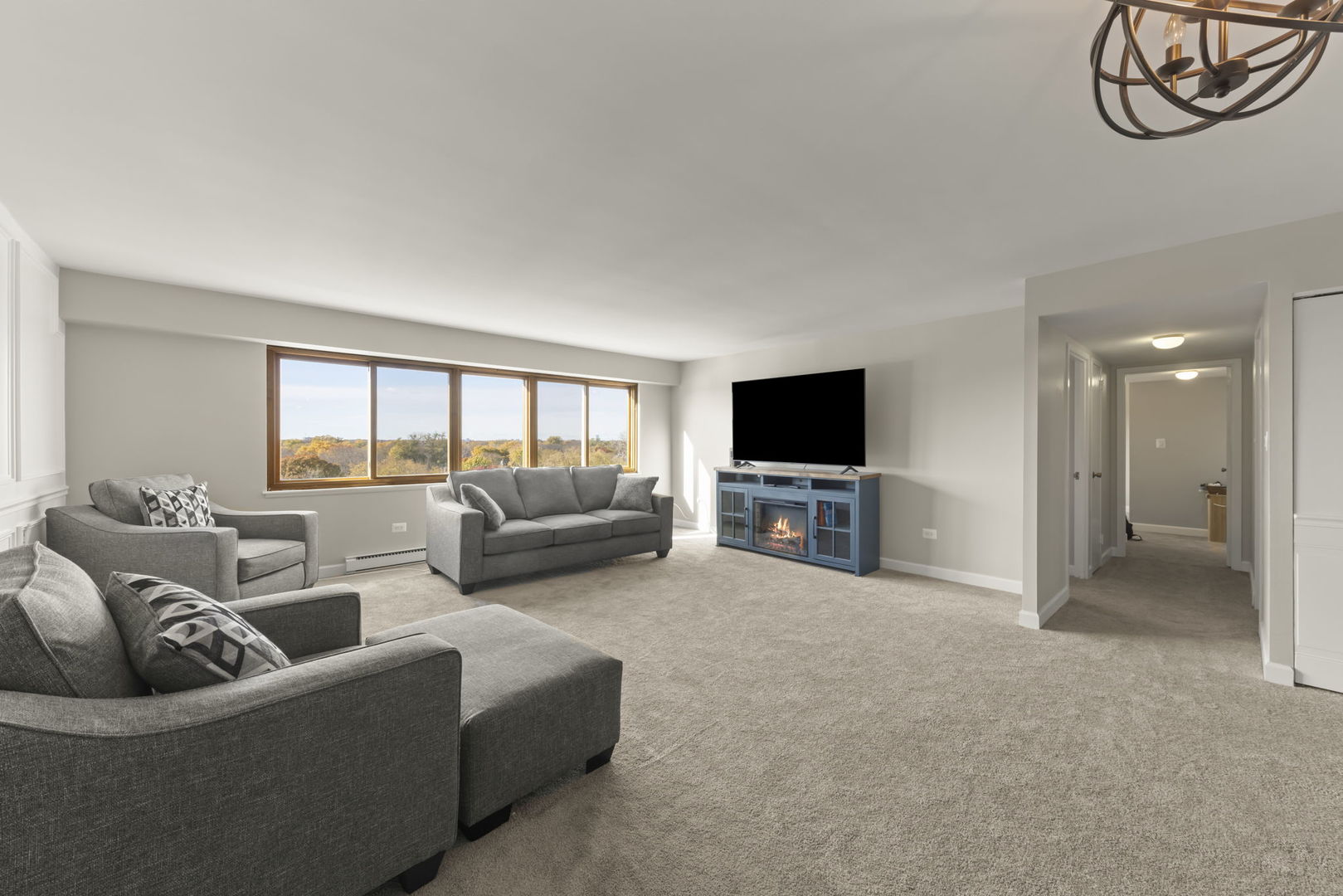 141 North La Grange Road, Unit 803 La Grange, IL 60525 - Photo 6 of 21 a living room with furniture and a flat screen tv