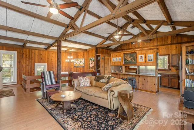 a living room with furniture and a kitchen view