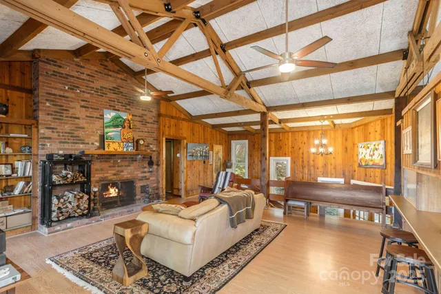 a living room with fireplace furniture and a floor to ceiling window