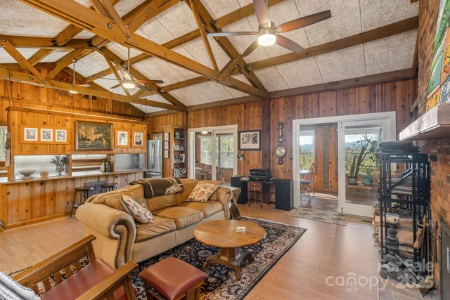 a living room with furniture and a floor to ceiling window