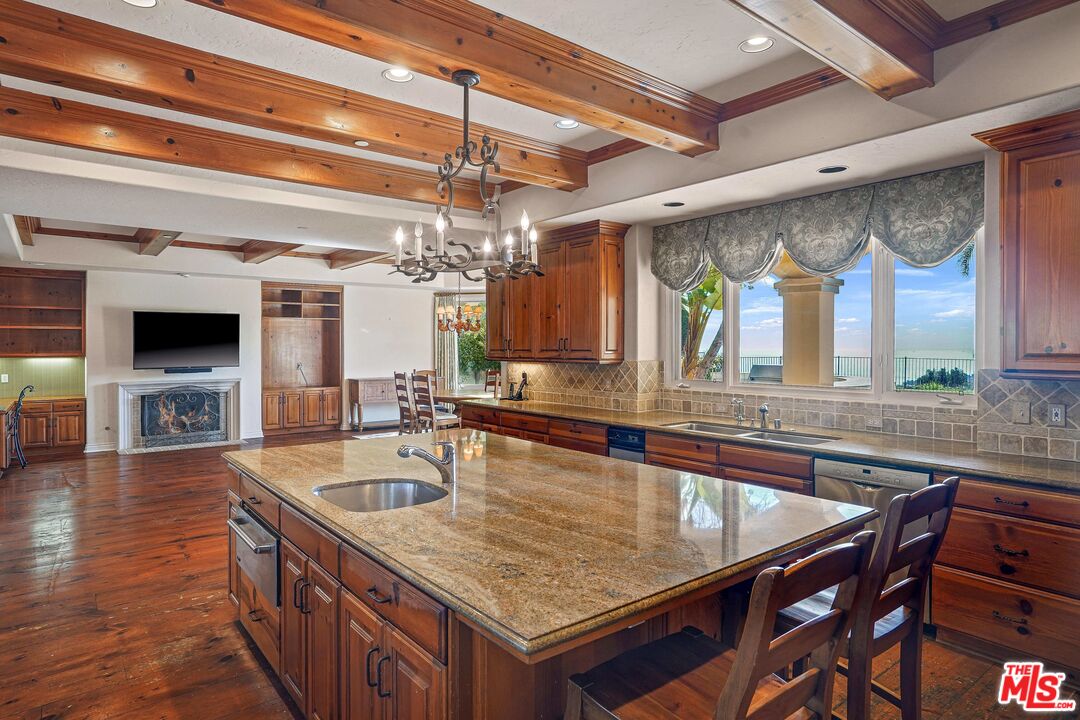 1452 Vía Cresta Pacific Palisades, CA 90272 - Photo 15 of 24 a kitchen with stainless steel appliances granite countertop a sink a stove and a wooden floors