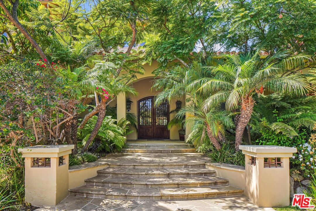 1452 Vía Cresta Pacific Palisades, CA 90272 - Photo 2 of 24 a front view of a house with a yard