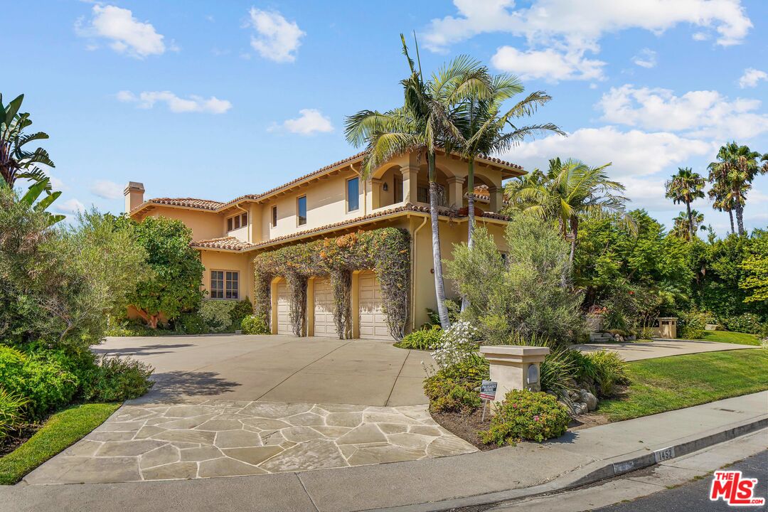 1452 Vía Cresta Pacific Palisades, CA 90272 - Photo 3 of 24 a front view of a house with a garden