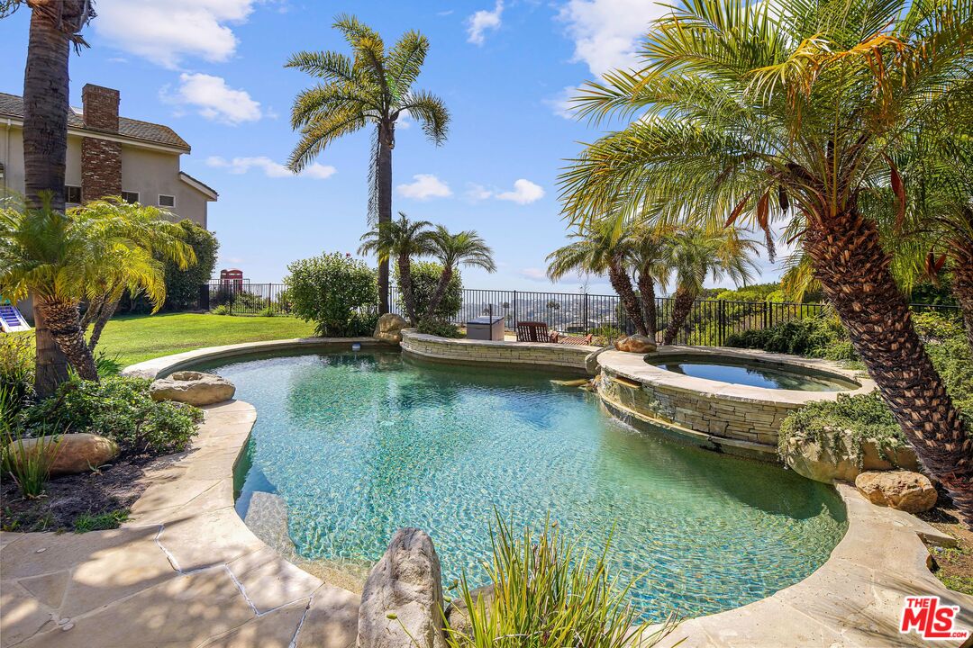 1452 Vía Cresta Pacific Palisades, CA 90272 - Photo 8 of 24 a view of a swimming pool with a garden