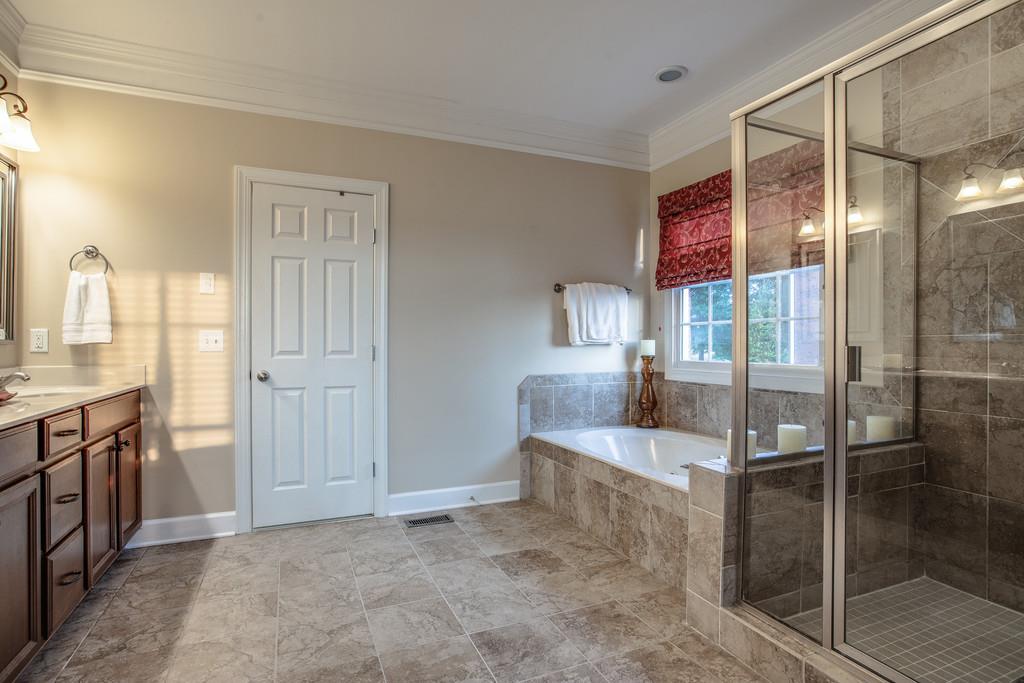 438 Beauchamp Circle Franklin, TN 37067 - Photo 13 of 30 a bathroom with a tub shower and sink