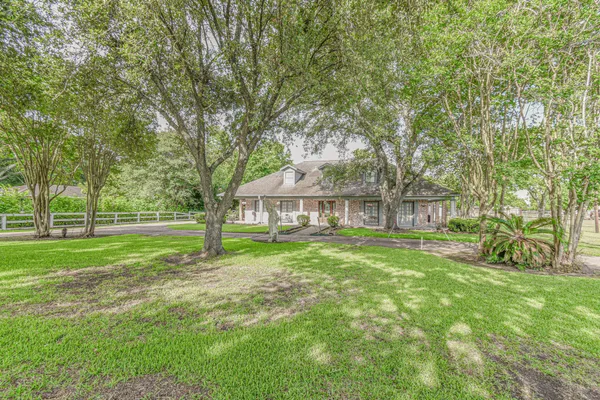 a view of a house with a yard and sitting area