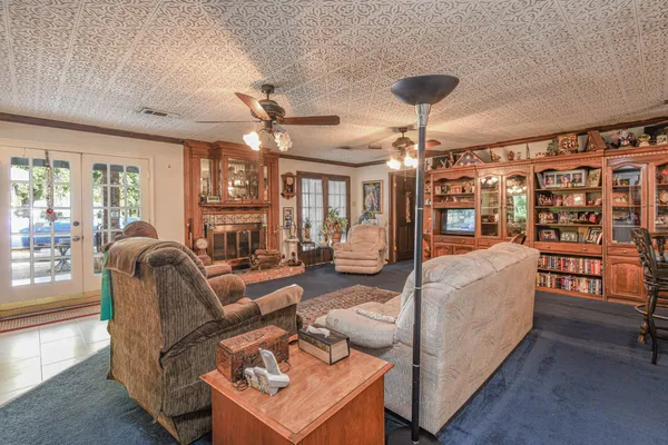 a living room with furniture and a chandelier