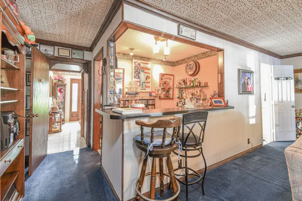 a dining room with stainless steel appliances a table and chairs