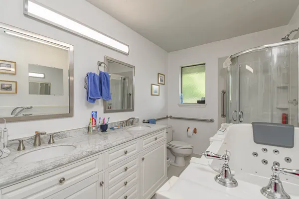 a bathroom with double sink and a mirror