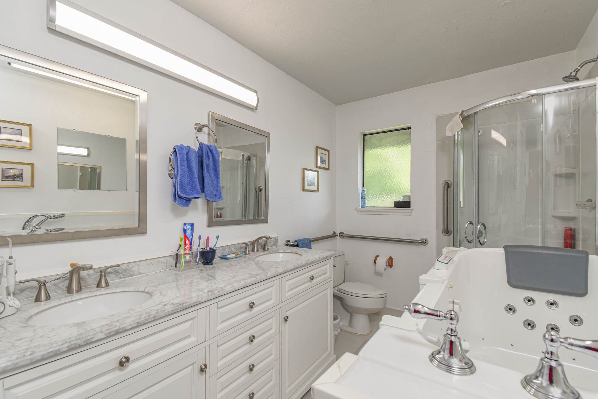 4503 Allen-Genoa Road Pasadena, TX 77504 - Photo 17 of 50 UPDATED PRIMARY BATHROOM: WALK IN SPA BATH TUB, SEPARATE SHOWER, DOUBLE SINK, MARBLE VANITY & NEW CABINETS