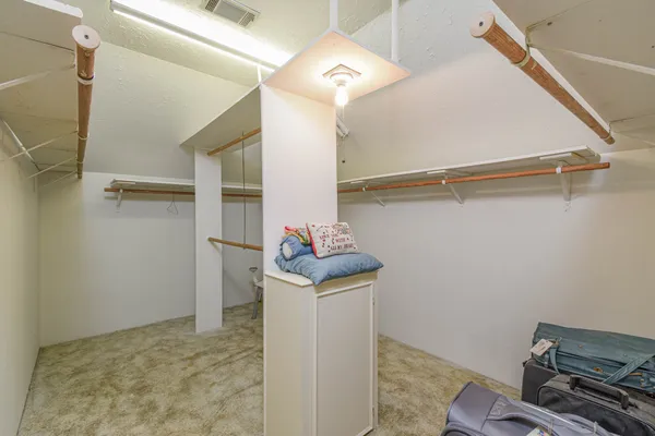 a spacious bathroom with a double vanity sink and a mirror