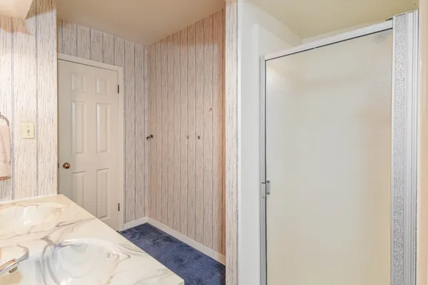 a bedroom with two beds and a chandelier