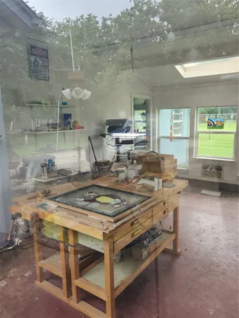 a kitchen with a sink a stove and chairs