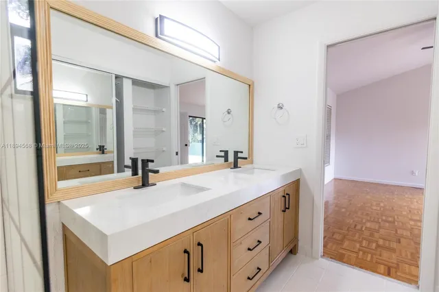a bathroom with a sink double vanity and a mirror