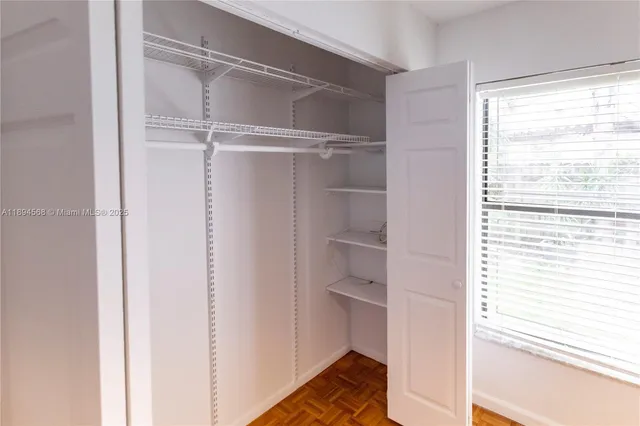 a view of closet area with empty racks