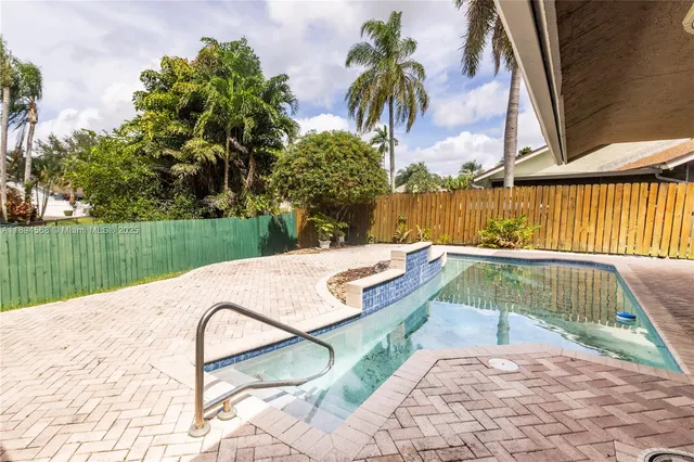 a view of a swimming pool with a patio