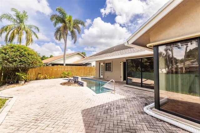 a view of a backyard with sitting area