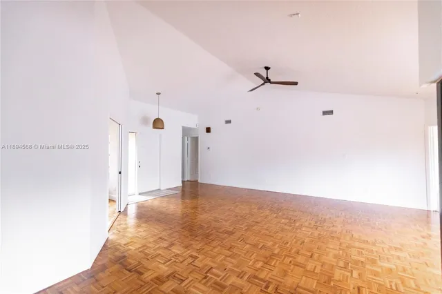 a view of a room with a ceiling fan