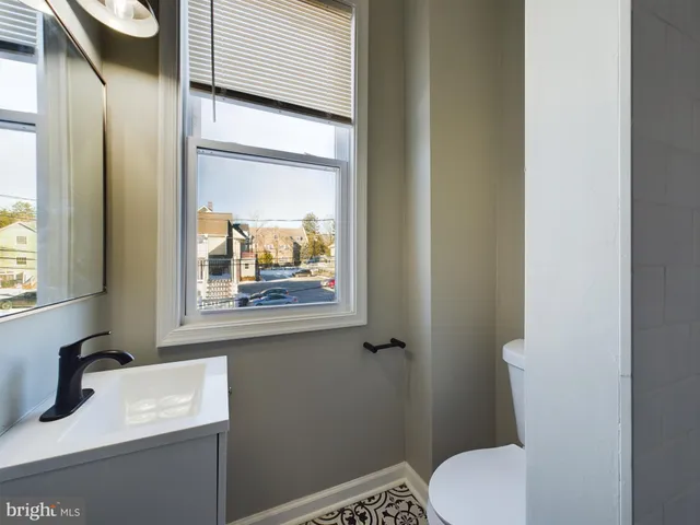 a bathroom with a toilet sink and mirror