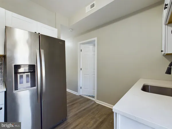 a kitchen with a refrigerator and a sink