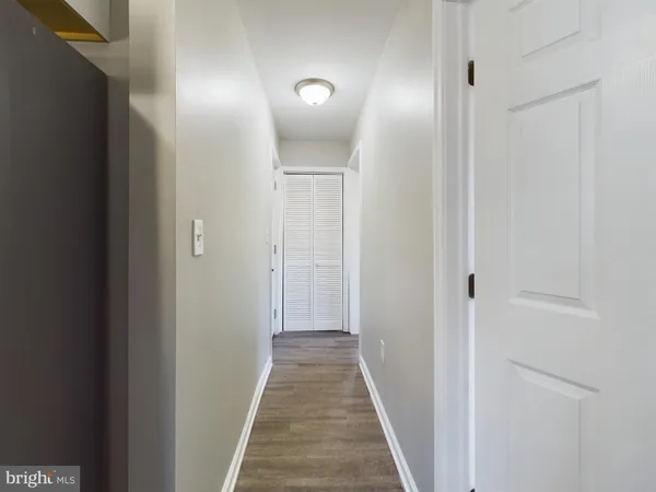 a view of a hallway with wooden floor