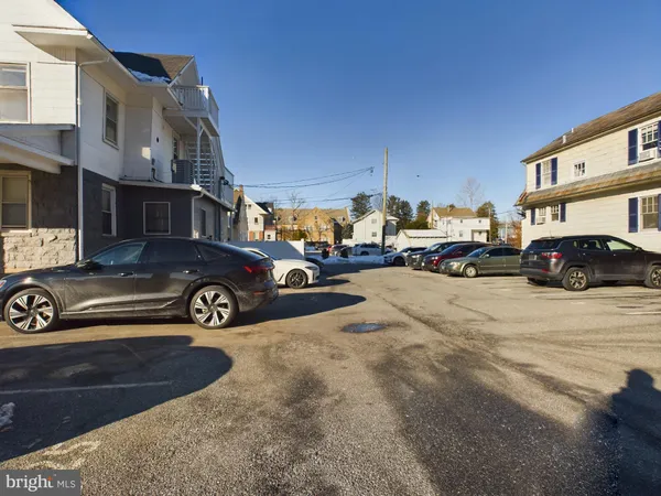 a view of a cars park in front of a building