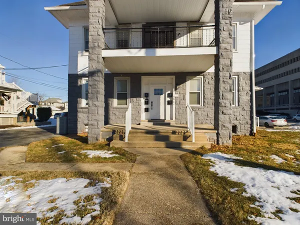 a view of a house with snow on the wall