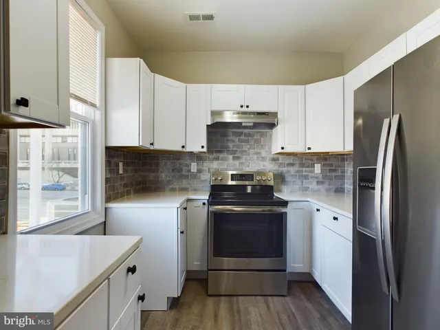a kitchen with a stove sink and refrigerator