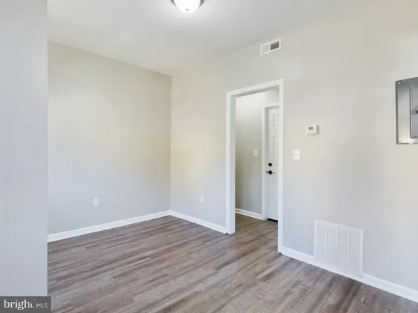 a view of an empty room with wooden floor