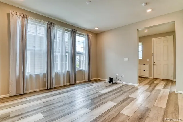 a view of a room with wooden floor and windows