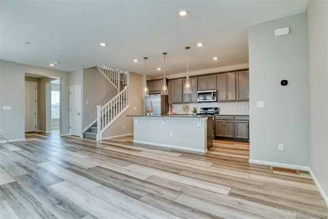 a view of kitchen with cabinets and wooden floor