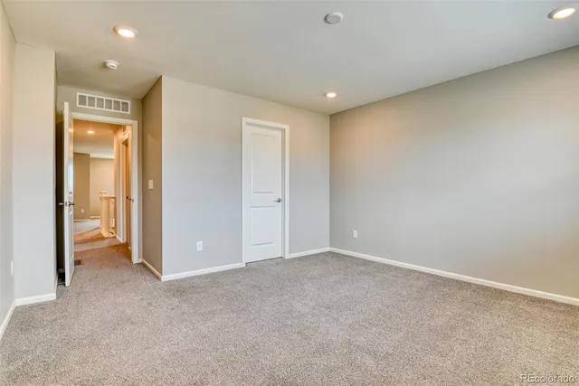 an empty room with closet area