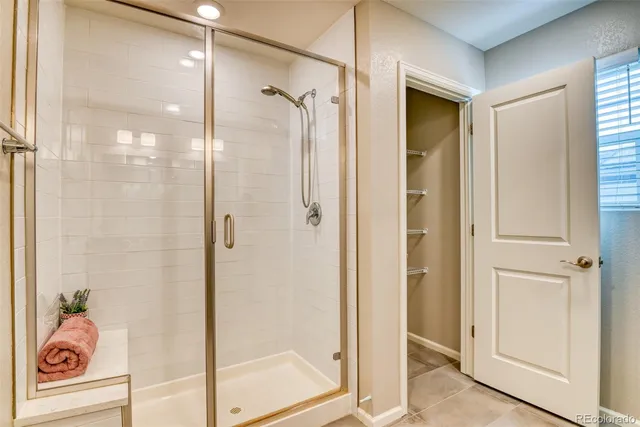 a bathroom with a shower and a glass door