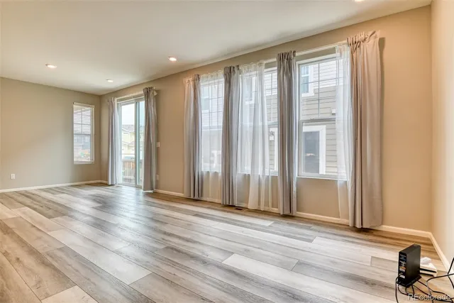 a view of a livingroom with wooden floor and a window
