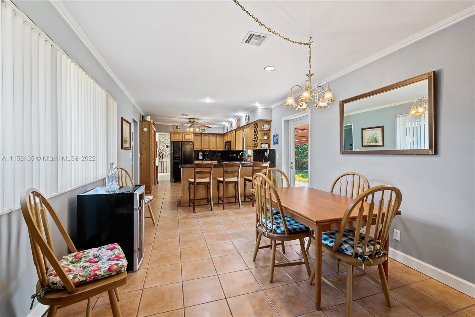 4314 Fillmore Street Hollywood, FL 33021 - Photo 11 of 27 a dining room with furniture and a chandelier