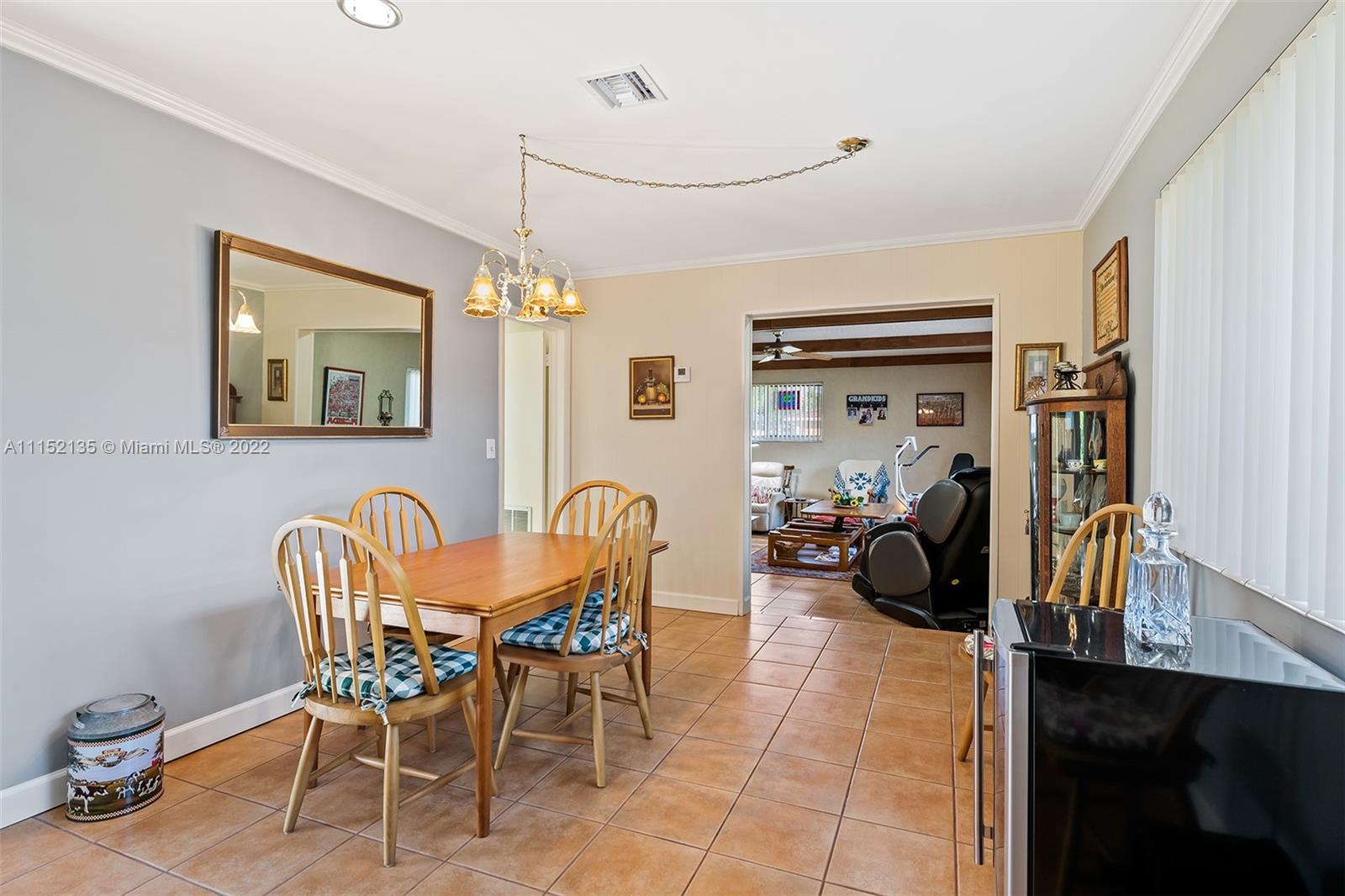 4314 Fillmore Street Hollywood, FL 33021 - Photo 12 of 27 a view of a dining room with furniture a chandelier and a window