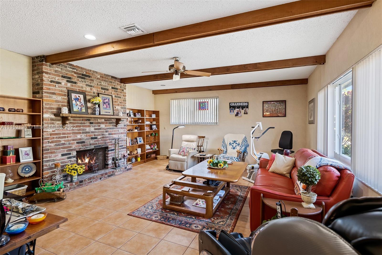 4314 Fillmore Street Hollywood, FL 33021 - Photo 13 of 27 a living room with fireplace furniture and a window