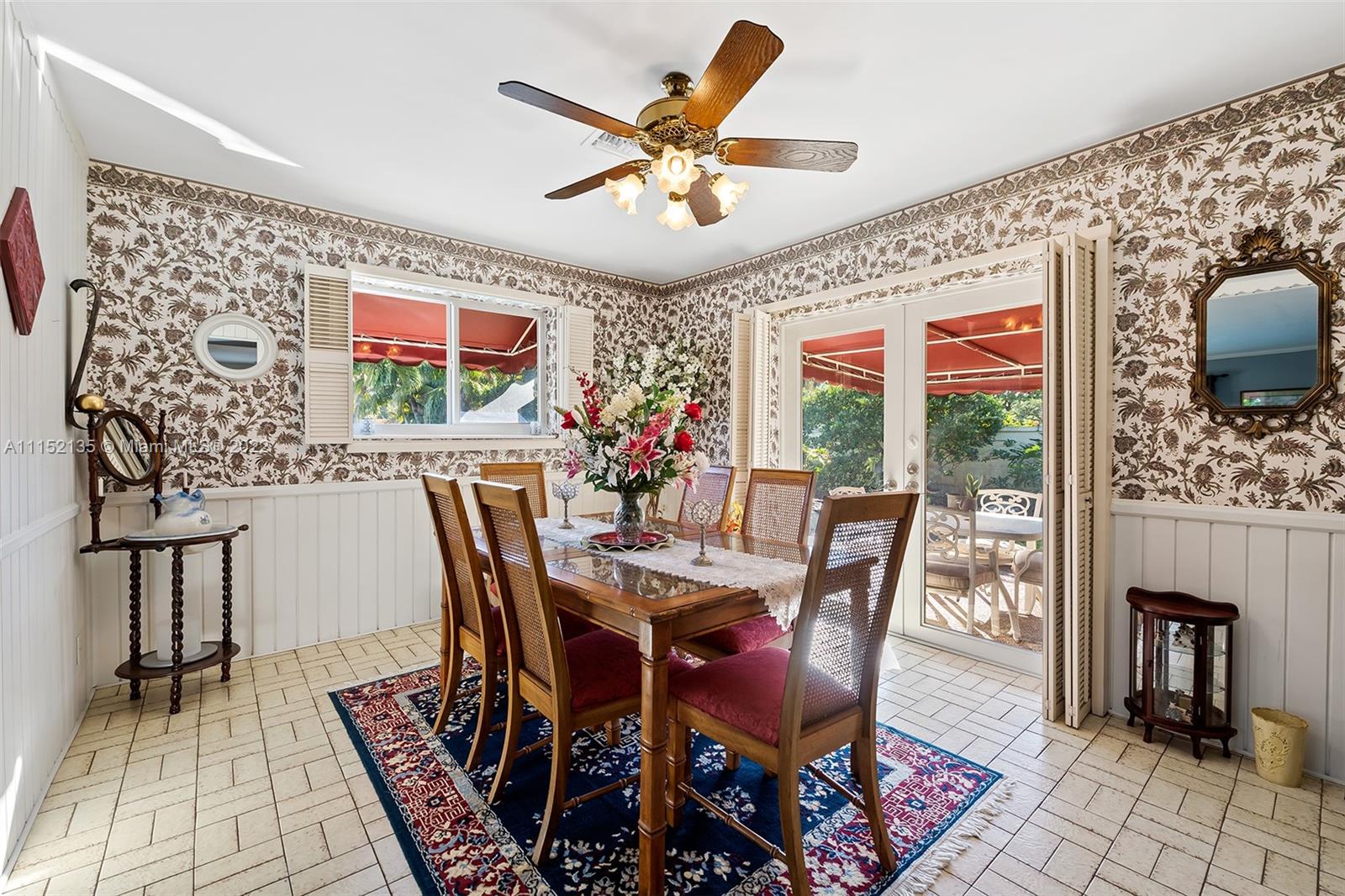 4314 Fillmore Street Hollywood, FL 33021 - Photo 15 of 27 a dining room with furniture garden view and a chandelier